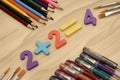 arithmetic example 2 plus 2 equals 4 on the table around the book pencils fountain pens the concept of education school Royalty Free Stock Photo