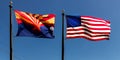 Arizona and US Flag fly in a blue sky Royalty Free Stock Photo