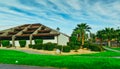 ARIZONA, USA - NOVEMBER 25, 2019: landscape design, trimmed green bushes near a house with palm trees, Arizona Royalty Free Stock Photo