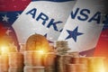 Arkansas US state flag and big amount of golden bitcoin coins and trading platform chart. Crypto currency Royalty Free Stock Photo