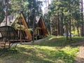 Arkhyz, Karachay-Cherkessia, Russia - August 24, 2022: Hotel in the form of wooden houses with a modern European design is set in