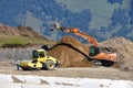 Arkhyz, Russia, Caucasus, September, 06, 2018. Case excavator and Bomag road tamping rink at the construction site of the ski reso