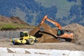 Arkhyz, Russia, Caucasus, September, 06, 2018. Case excavator and Bomag road tamping rink at the construction site of the ski reso
