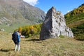 Arkhyz, Russia, Caucasus, September, 07, 2018. Tourist takes pictures of big rock in the valley of the river Kyafar-Agur Royalty Free Stock Photo