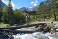 Arkhyz, Russia, Caucasus, September, 12, 2018. Tourist crossing the mountain river Sofia