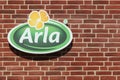 Arla Foods logo on a brick wall