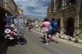 Tourists pass souvenir shops next to the Arenes d`Arles, Roman Amphitheater