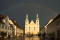 Arlesheim Cathedral after a thunderstorm. The sky is dark with a rainbow, the evening sun is illuminating the cathedral. Arlesheim Royalty Free Stock Photo