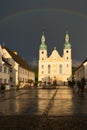 Arlesheim Cathedral after a thunderstorm. The sky is dark with a rainbow, the evening sun is illuminating the cathedral. Arlesheim Royalty Free Stock Photo