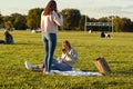 Two young woman are relaxing in Gravelly Point park at a sunny afternoon. Royalty Free Stock Photo