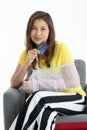 Arm broken beautiful Asian woman with arm sling showing and using credit card. Studio shot white background. Concept for expense Royalty Free Stock Photo