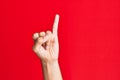 Arm of caucasian white young man over red isolated background showing little finger as pinky promise commitment, number one Royalty Free Stock Photo