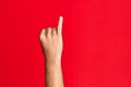 Arm of caucasian white young man over red isolated background showing little finger as pinky promise commitment, number one Royalty Free Stock Photo