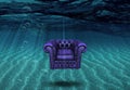 Arm chair floats above bottom of sea Royalty Free Stock Photo