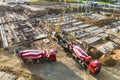 Arm of concrete pump ready for concrete conveying at construction site. Jib of concrete pump truck against sky at background. Royalty Free Stock Photo