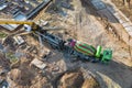 Arm of concrete pump ready for concrete conveying at construction site. Jib of concrete pump truck against sky at background. Royalty Free Stock Photo