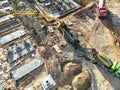 Arm of concrete pump ready for concrete conveying at construction site. Jib of concrete pump truck against sky at background. Royalty Free Stock Photo