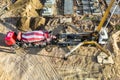 Arm of concrete pump ready for concrete conveying at construction site. Jib of concrete pump truck against sky at background. Royalty Free Stock Photo