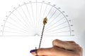 Arm of a dowser with hand-held pendulum over the chart. Royalty Free Stock Photo