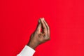 Arm and hand of african american black young man over red isolated background doing italian gesture with fingers together, Royalty Free Stock Photo