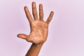 Arm and hand of black middle age woman over pink isolated background counting number 5 showing five fingers Royalty Free Stock Photo