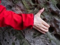 Arm in jacket on weathered sandstone rock Royalty Free Stock Photo