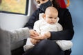 The arm of a little girl taking pistachios from the hand of her mother Royalty Free Stock Photo