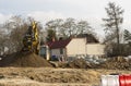 Construction site in the city. Crawler excavator heaps of earth, sand and rubble.