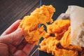 arm and meat strips on a black tray. strips of meat fried in breading. Royalty Free Stock Photo