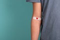 Arm with plaster and heart, blood cells, donate plasma, world blood donor day, health care, transfusion, Leukaemia disease Royalty Free Stock Photo