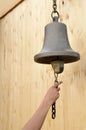 Arm ringing a bronze bell