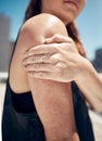 Arm, shoulder and exercise woman injury, athlete training, and fitness workout in outdoor urban city. Closeup joint pain