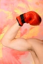 Arm with strong biceps wearing red leather boxing glove Royalty Free Stock Photo