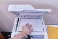 Arm of a white or caucasian man making a photocopy on a photocopier in the office