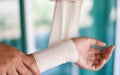 Arm wound bandaging hand and by nurse / first aid wrist injury health care and medicine Royalty Free Stock Photo