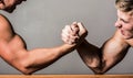 Arm wrestling. Two men arm wrestling. Rivalry, closeup of male arm wrestling. Two hands. Men measuring forces, arms