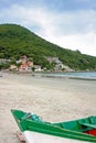 ARMACAO, FLORIANOPOLIS, SANTA CATARINA, BRAZIL. Colorful boat on the beach. The town in a background. Royalty Free Stock Photo