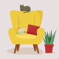 Armchair with books and a pillow. A cozy chair on which the cat sits. Furniture and houseplants. a place to relax and read books.