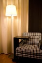 Armchair and lamp in hotel