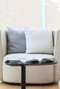 Armchair sofa with pillows coffee and book home interior