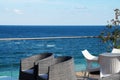 Armchairs and a table for relaxing on the patio overlooking the sea