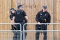Armed British police officers policing an outdoor event