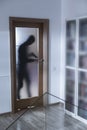 Armed burglar breaking into house