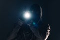 Armed burglar intruder with flashlight torch at night Royalty Free Stock Photo