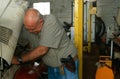 An armed man working in a garage, South Africa Royalty Free Stock Photo