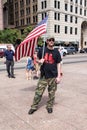 Armed Militia Member Holds up American Flag at Demonstration in Support of Second Amendment in Columbus Ohio