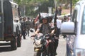 Armed police stan guard behind police line