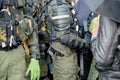 Armed police stand in the pouring rain to disperse the protesters