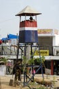 Armed policeman in a tower police post. India.