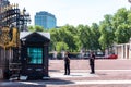 Armed policemen guarding the gates of Buckingham Palace in London Royalty Free Stock Photo